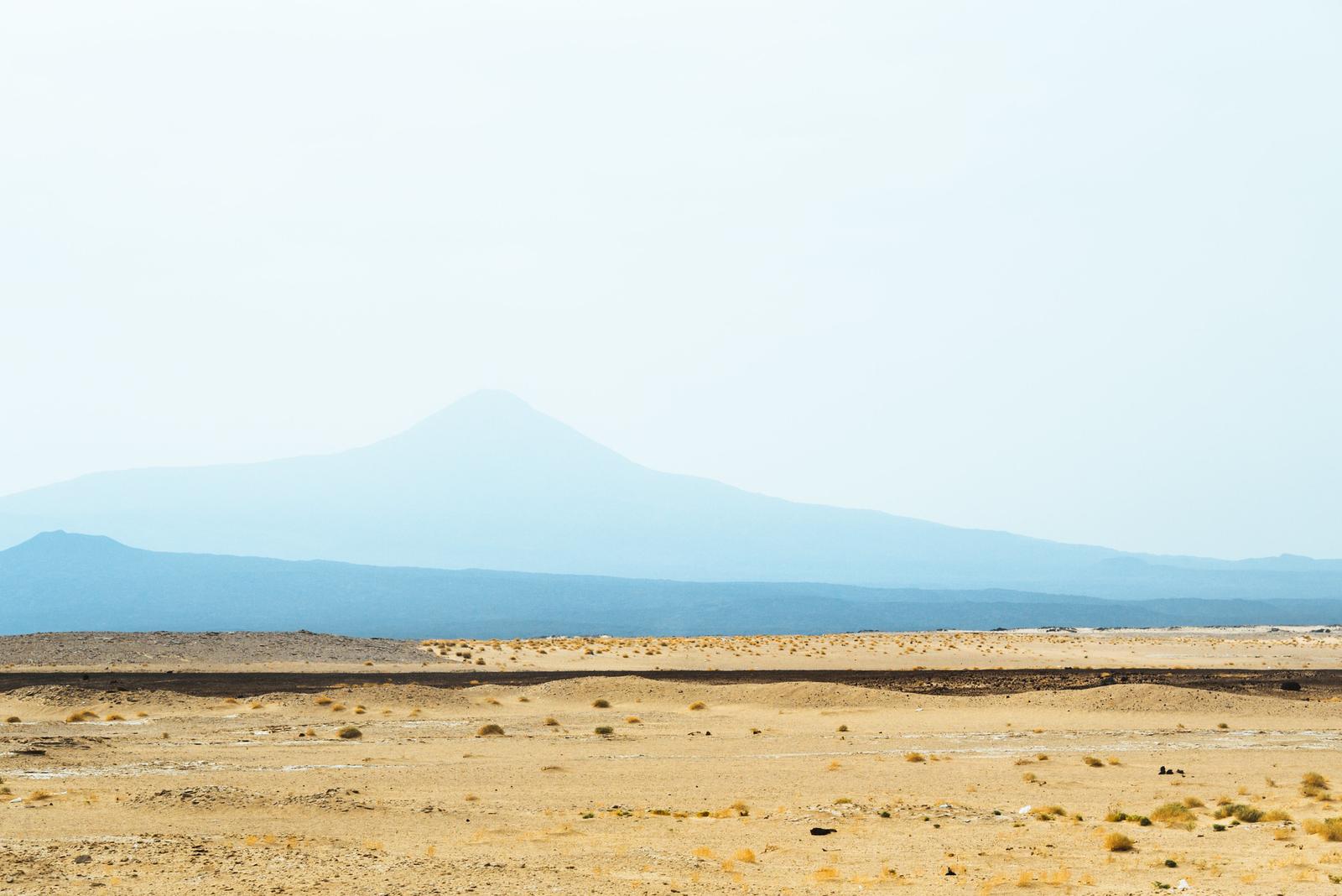 Desert on Top of Mountainous Backdrop